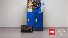Load image into Gallery viewer, Blue lockers with sports goods, bags, and a black duffel bag on the floor, featuring LEGO and Herschel logos.