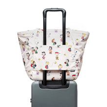 Load image into Gallery viewer, Back panel view of the Joana tote bag attached to the telescopic handle of a suitcase.