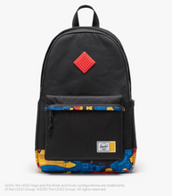 Load image into Gallery viewer, Front panel view of the black backpack with colorful abstract lego brick pattern accents.