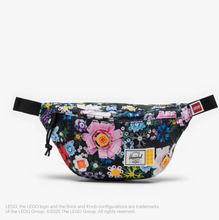 Load image into Gallery viewer, Front view of the hip pack with Lego bricks floral pattern.