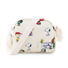 Load image into Gallery viewer, Front view of Peanuts pattern crossbody bag with the adjustable shoulder strap resting across the front.