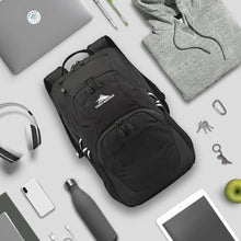 Load image into Gallery viewer, The black backpack arranged with electronics, keys, and clothes on a white background.