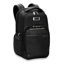 Load image into Gallery viewer, Angled front view of the black backpack. It features three zipper-closing pockets on the front, and one on the side with an open phone compartment.