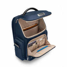 Load image into Gallery viewer, Briggs & Riley @Work Medium Widemouth Backpack in Navy
Image of Front Panel Angled View showing main compartment open with ample space for your larger items, shoes, clothing, etc.
Also showing the front zippered organizer pocket with slots for pens, cards, passport, airline ticket, cables, keys, etc.
Dimensions: 17 x 14.5 x 8 in / 43.2 x 36.8 x 20.3 cm