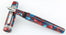 Load image into Gallery viewer, The fountain pen with the nib resting on the cap.