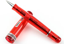 Load image into Gallery viewer, The rollerball pen with the grip section resting on the cap.