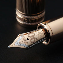 Load image into Gallery viewer, Close up to the Fountain Pen nib with the cap placed behind it. Set on a black background.