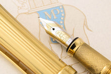 Load image into Gallery viewer, Close up to the fountain pen nib with engraved decorations, 18k gold hallmark, Michel Perchin logo, and the letter M.