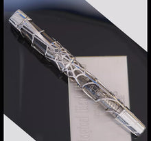 Load image into Gallery viewer, Front view of the Montblanc Black Widow Fountain Pen in Solid White Gold. The pen is set on top of the presentation box, which has a plate with an engraving.