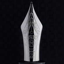 Load image into Gallery viewer, Close Up to the Fountain Pen. An elaborate decoration is engraved upon it with the details: 4810, The Montblanc Logo, and the hallmarks for the nib's material, indicating they are 18K,750 gold.