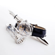 Load image into Gallery viewer, The Fountain Pen placed with the cap off and the included watch on a white background.