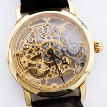 Load image into Gallery viewer, Front view of the intricate gold watch.