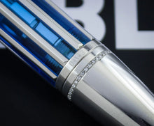 Load image into Gallery viewer, Close-up of the grip section showing small clear rhinestones, photographed against a dark background with a blurred white-and-black graphic.