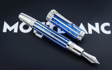 Load image into Gallery viewer, The Montblanc fountain pen with its cap removed, displayed diagonally on a dark background with the Montblanc logo partially visible.