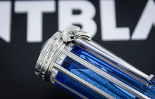 Load image into Gallery viewer, A close-up of the blue and silver gold pen featuring a sculpted silver eagle head cap, set against a dark background with a blurred white logo.