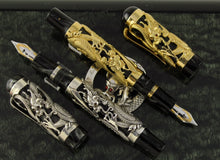 Load image into Gallery viewer, The Montegrappa 1995 Dragon fountain pens, uncapped, in gold and silver overlay, featuring intricate dragon engravings on black marbled celluloid bodies, displayed on a dark background.