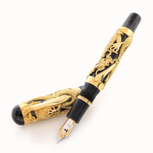 Load image into Gallery viewer, The Montegrappa 1995 Dragon fountain pen, uncapped, in gold overlay, featuring an intricate dragon design on a black marbled celluloid body, displayed on a white background.