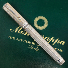 Load image into Gallery viewer, Front view of the Fountain Pen. It is placed on top of the outer green box. The pens clip is facing up, and a series of complex engravings decorate the body and cap.
