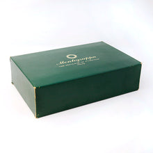 Load image into Gallery viewer, Angled view of the outer green box. It shows some scuff marks on the edges.