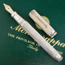 Load image into Gallery viewer, Front view of the pen. The cap has been removed and placed to the side. The nib is features some small golden accents, and the grip section has engraved the word "Montegrapa" in cursive.