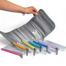 Load image into Gallery viewer, A hand holding the extended bag with the six pouches fanned in front.