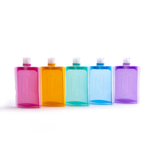 Load image into Gallery viewer, The pink, orange, aqua, blue, and purple travel bottles arranged on a white background.