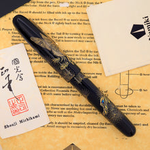 Load image into Gallery viewer, Decorative fountain pen on a paper background with the artist card.