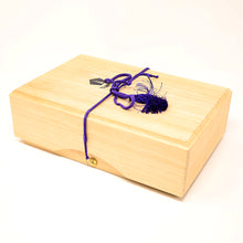 Load image into Gallery viewer, Wooden box with a purple cord and decorative elements on a white background.