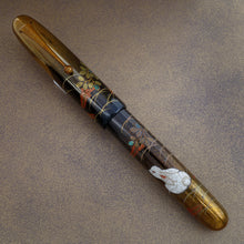 Load image into Gallery viewer, The image shows the Rabbit on Moonlight pen with it's cap on the barrel at a different angle.