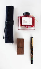 Load image into Gallery viewer, The Benzaiten fountain pen arranged on a white background with the ink bottle, wooden box, and pen case.