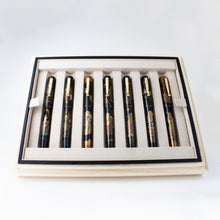 Load image into Gallery viewer, Front view of the Seven Gods of Good Fortune Fountain Pens arranged in the presentation box.
