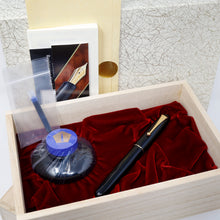Load image into Gallery viewer, The fountain pen arranged in its presentation box with the included ink bottle, ink, pamphlets and outer boxes.