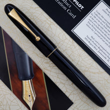 Load image into Gallery viewer, Front view of the black fountain pen arranged on top of the outer box with the included pamphlets.