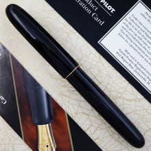 Load image into Gallery viewer, Back view of the fountain pen arranged on top of the outer box with the included pamphlets.