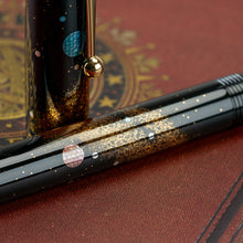 Load image into Gallery viewer, Close Up to the pen's barrel. There is a dusting of golden powder meant to represent the design of the Milky Way and stars.
