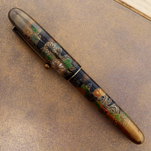 Load image into Gallery viewer, Side view of the Fountain Pen, set on the lid of the outer box.
