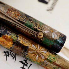 Load image into Gallery viewer, Close Up to the flower design on the cap and barrel. Different types of gold dust and mother of pearl pieces were used to decorate the petals.