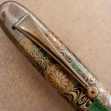 Load image into Gallery viewer, Close Up to the pen's nib. The nib is painted in the same golden dust used around the pen.