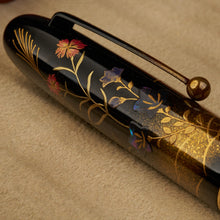 Load image into Gallery viewer, Close up to the blue, red, and abalone shell flowers painted on the cap.