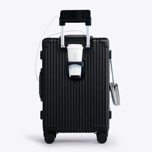 Load image into Gallery viewer, Back panel view of the black suitcase showing a phone held by the telescopic handle and a hot drink in the cup holder.