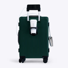 Load image into Gallery viewer, Back panel view of the green suitcase showing a phone held by the telescopic handle and a hot drink in the cup holder.