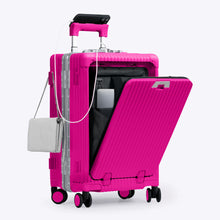 Load image into Gallery viewer, Angled front view of the hot pink carry-on with the front panel opened. It is arranged with a charging cellphone, a small purse, and a laptop in its compartment.