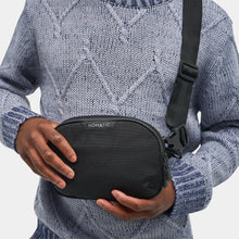 Load image into Gallery viewer, A young man carrying the black sling bag.
