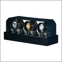 Load image into Gallery viewer, A black automatic watch winder with three rotating watch cushions displaying gold, and silver watches, shown on a white background.