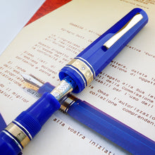 Load image into Gallery viewer, Close up to the cap and nib, placed on top of a printed document.