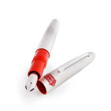 Load image into Gallery viewer, Angled view of the fountain pen arranged with the cap next to it on a white background.