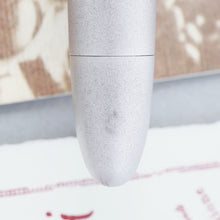 Load image into Gallery viewer, Close up to a small scuff mark on the bottom of the pen.
