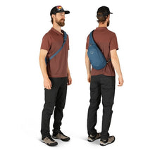 Load image into Gallery viewer, Front and back angled views of a young man carrying a blue sling bag.