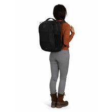 Load image into Gallery viewer, A young woman carrying the black backpack.