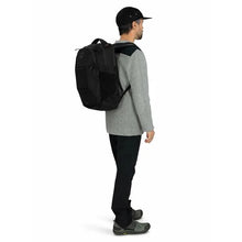 Load image into Gallery viewer, A young man carrying the black backpack.